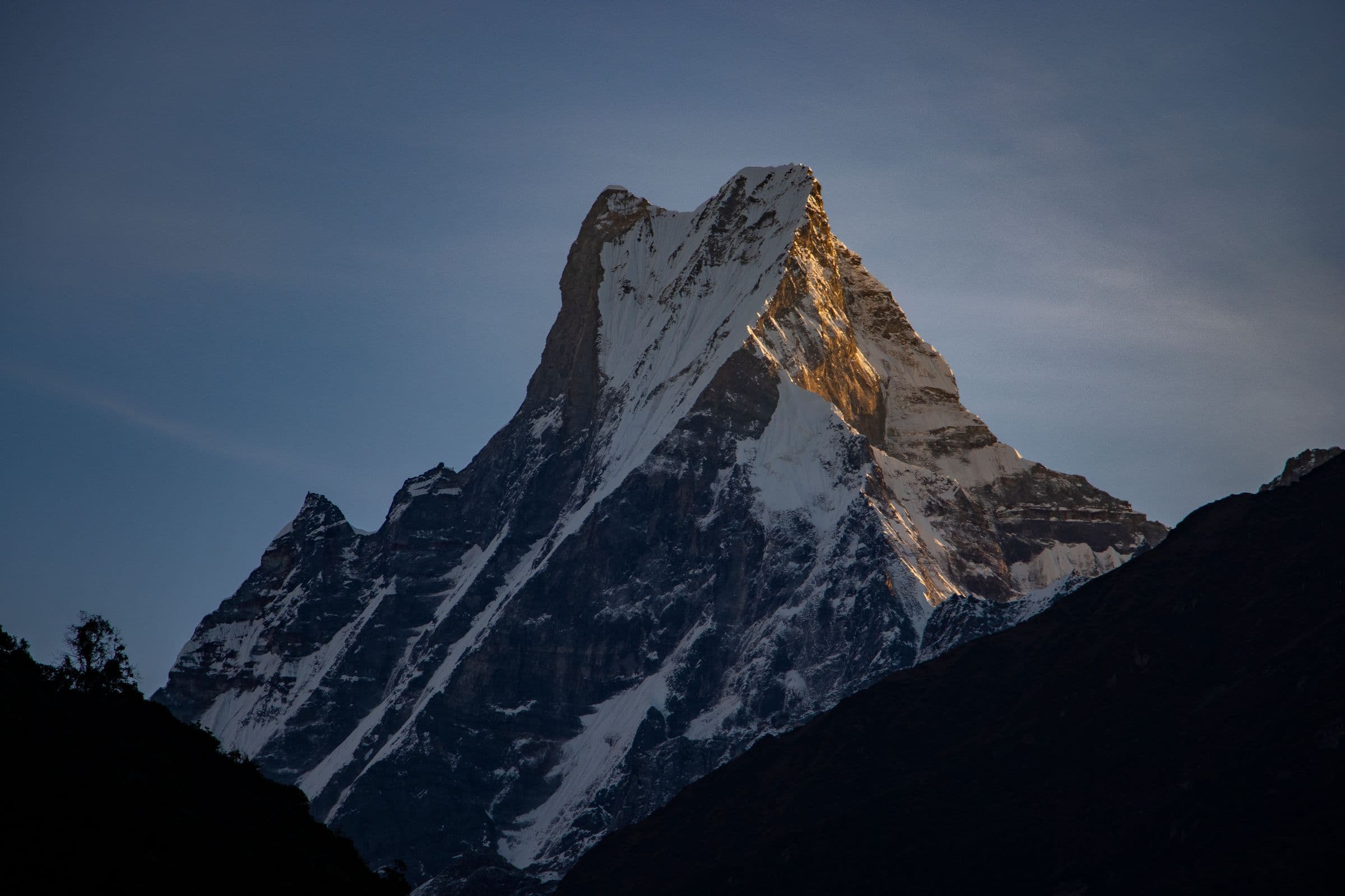Breathtaking view of the snowy peak of Machapuchare in the Himalayas at sunrise.