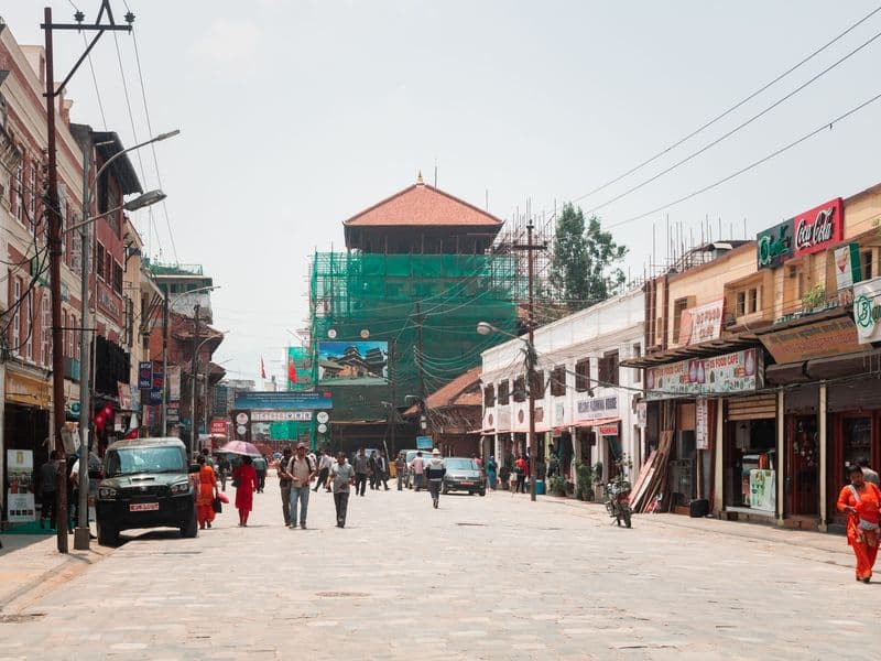 Vibrant street scene in Kathmandu featuring shops, tourists, and traditional architecture.