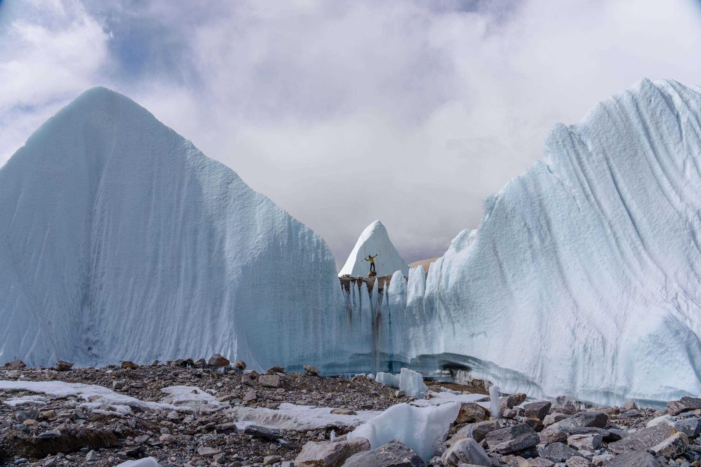 A lone climber atop stunning ice formations, capturing the beauty of winter's frozen landscapes.