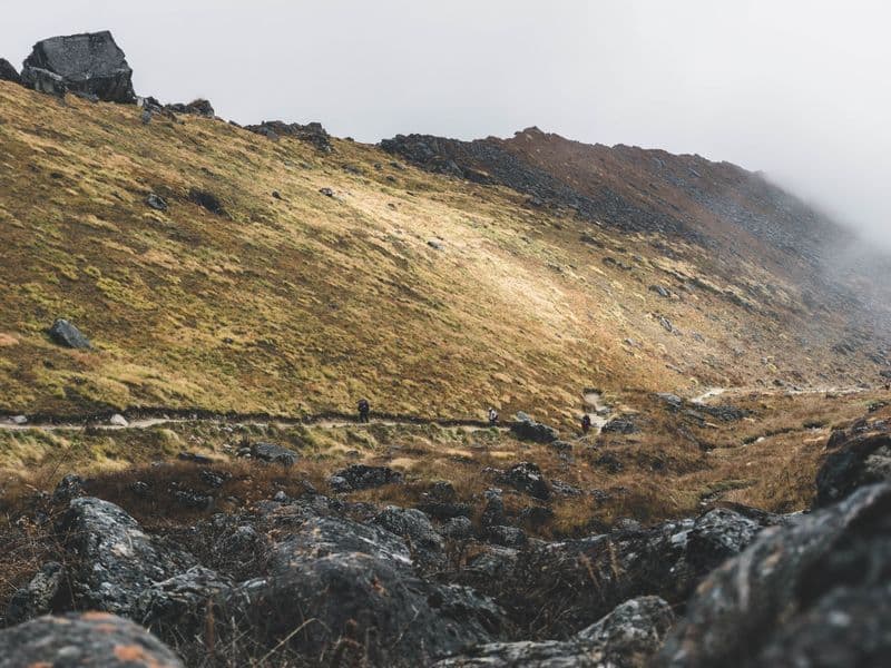 Foggy mountain landscape with a rocky trail in Annapurna, Nepal.