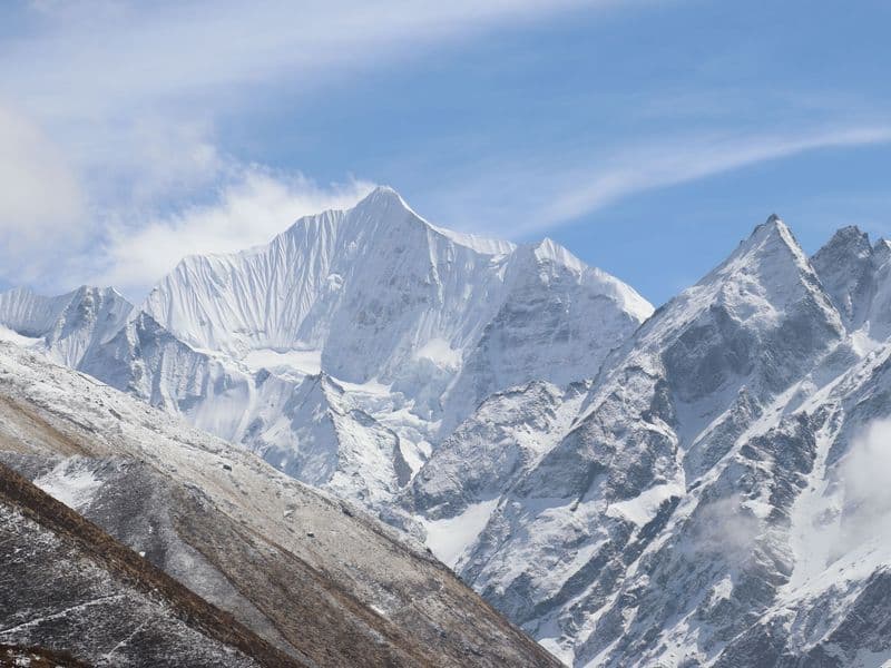 Majestic snow-covered Langtang mountains under a clear blue sky in Nepal